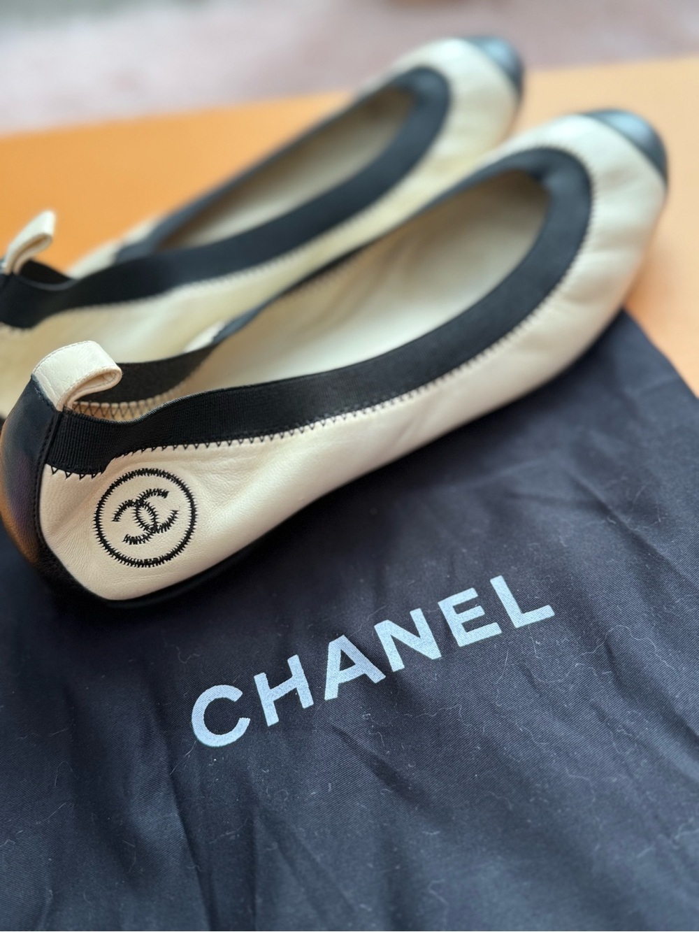 CHANEL Cream and Black Ballet Flats with CC Heel Stitch